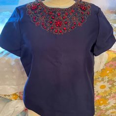 Beautiful Cotton/Silk Blend Fully Lined Short Sleeve Top. Exquisite Beading And Extra Beads Included. Zips In Back For A Clean, Tailored Look. Beaded Short Sleeve Tops For Evening, Elegant Short Sleeve Tops With Rhinestones, Elegant Beaded Short Sleeve Tops, Elegant Blue Embellished Top, Blue Embellished Top With Short Sleeves, Blue Embellished Short Sleeve Top, Blue Embellished Top For Evening, Cotton Silk, Short Sleeves Tops