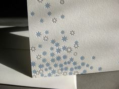 two folded cards with blue stars on them