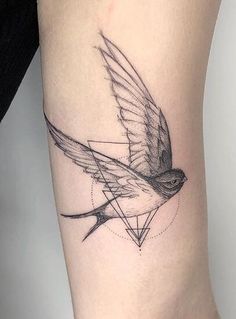 a small bird tattoo on the right side of the leg, with an inverted triangle in the middle