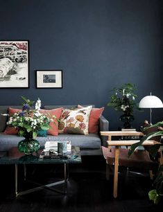 a living room filled with furniture and decor on top of a hard wood floored floor