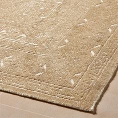 a beige rug with white designs on it