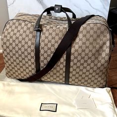 Size Base Length: 16.50 In Width: 8.75 In Height: 11.00 In Drop: 4.50 In Drop: 12.00 In To 0.00 In Comes With Strap Dust Bag Original Gift Receipt Description This Is An Authentic Gucci Monogram Boston Duffle Bag In Dark Brown. This Duffel Bag Is Crafted Of Gucci Gg Monogram Canvas. The Bag Features Textured Dark Brown Leather Top Handles, Leather Trim, An Optional Canvas Shoulder Strap And Silver Hardware. The Top Zipper Opens To A Spacious Nylon Mocha Fabric Interior With Zipper And Patch Pock Gucci Beige Bag With Logo, Gucci Business Bag With Logo, Luxury Beige Duffle Bag, Brown Monogram Canvas Duffle Bag, Elegant Brown Duffle Bag For Shopping, Classic Monogram Canvas Duffle Bag, Gucci Travel Bags With Logo, Gucci Brown Travel Bag, Designer Brown Travel Bag With Gold-tone Hardware