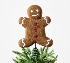 a christmas ornament made to look like a gingerbread man hanging from a tree