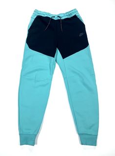 Elevate your activewear collection with these Nike Sportswear Tech Fleece Joggers Pants in a stylish washed teal and black color combination. The pants are designed with a drawstring closure, elastic waist, taped seams, and adjustable waist for a comfortable and breathable fit. The cotton blend material and fleece fabric type make it perfect for fall, winter, and spring seasons. These pants also come with easy care, zip pocket, pockets, and slim fit features that make it ideal for gym and traini