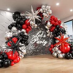 the balloon arch is decorated with black, red and silver balloons