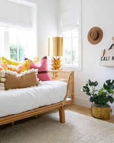 a living room filled with lots of furniture and pillows on top of a white couch