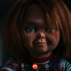 a creepy looking doll with blue eyes and red hair