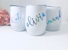 three white coffee mugs with hand painted words on them