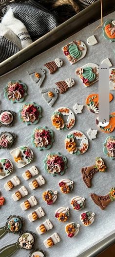 an assortment of buttons are displayed on a tray