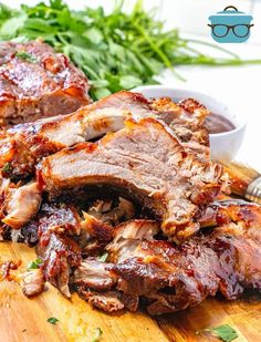 sliced pork on a cutting board with sauce and parsley in the backgroud