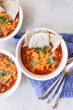 three bowls of chili soup with tortilla chips