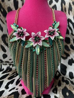 Hi there! Up for sale is a 100% authentic Betsey Johnson lily chain bib necklace from her "Lily Flower" Collection. This necklace is new with tags, retired and SOLD OUT. The necklace consists of a thick gold colored chain which connects to sparkly green rhinestones and crystal embellished lily flowers. A gold and green enameled chain bib hangs below. This is a gorgeous piece and would be perfect for any Betsey Johnson collector or fan! Please check out my store for more rare and unique Betsey pi Lily Flowers, Flower Collection, Flower Green, Gold And Green, Betsey Johnson Jewelry, Lily Flower, Bib Necklace, Fashion Jewelry Necklaces, High Heel Boots