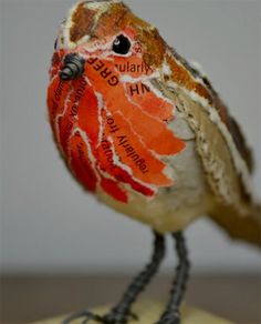 a small bird sitting on top of a wooden block