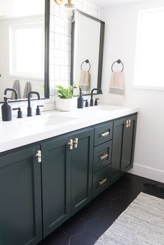 a bathroom with two sinks and mirrors in it