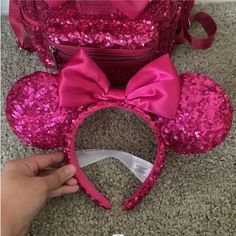 the pink minnie mouse ears have been made with sequins and are ready to be put on