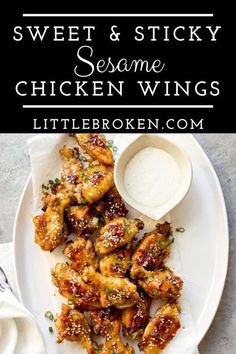 sweet and sticky sesame chicken wings on a white plate with dipping sauce next to it