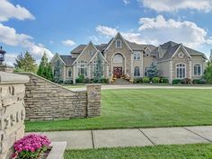 a large house in the middle of a lush green yard