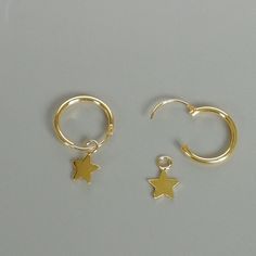 A PAIR of sterling silver hoops dipped in gold. Comes with a tiny star charm. The charm is multipurpose and can be used with a neck or bracelet chain too. Dimension: Hoop- 12x1 mm Charm- 5x5 mm Drop length- 18mm Price listed is for ONE PAIR These are made of 925 hypoallergenic sterling silver plated in gold. Most of my pieces come with a 925 stamp. Can be packaged in a gift box. I can include a personal message from you if needed You are welcome to contact me at... bhavnakwintra1956@gmail.com Fo Celestial Hoop Earrings With Star Charm For Everyday, Celestial Small Hoop Earrings With Star Charm, Minimalist Gold Hoop Earrings With Star Charm, Everyday Dainty Huggie Earrings With Star Charm, Dainty Hoop Earrings With Star Charm, Dainty Small Hoop Jewelry With Star Charm, Everyday Small Hoop Star Charm Jewelry, Everyday Small Hoop Jewelry With Star Charm, Celestial Huggie Hoop Earrings For Everyday