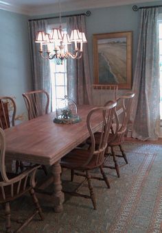 a dining room table with chairs and a chandelier