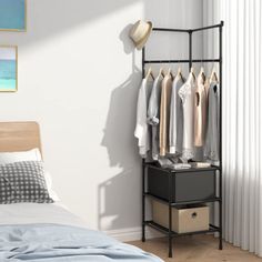 a bedroom with a bed, dresser and clothes rack