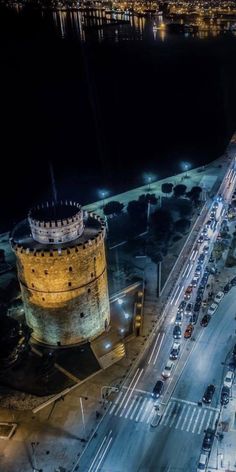 an aerial view of a city at night with cars parked on the side of the road