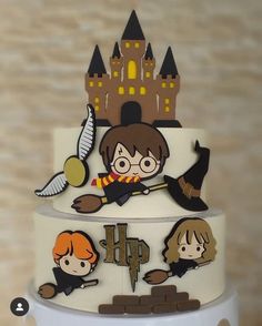 a three tiered cake decorated with harry potter characters