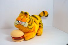 a stuffed animal that looks like a tiger with a hamburger in it's mouth