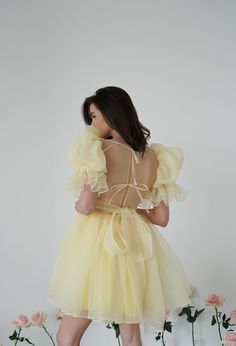 Introducing the Britney Dress in a delightful light yellow: a stunning creation crafted from delicate bubble organza. This lightweight dress features an elegant silhouette with a voluminous floating skirt that moves gracefully with every step. The charming puff sleeves add a whimsical touch, making it perfect for any special occasion. The Britney Dress is enclosed with delicate bow ties down the back, adding a romantic and feminine detail that completes the look. In light yellow, this dress exud Organza Dress Ideas, Courthouse Wedding Dress, Fancy Short Dresses, Midi Wedding Dress, Bachelorette Party Dress, Spring Wedding Dress, Rehearsal Dinner Dresses, Pink Wedding Dresses, Red Wedding Dresses