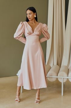 Fabric: Heavy Satin Cotton 50%, Polyester 50% V-neck dress Puffed sleeves Long sleeves Bow on back detail Zipper on back Dress lenght: 125 cm/ 49,2 inSleeve length: 68 cm/ 26,7 in Colors: White, Sky-Blue, Dusty Pink Fitted V-neck Dress With Gathered Sleeves, Fitted V-neck Dress With Gathered Sleeves For Party, V-neck Maxi Dress With Elastic Sleeves For Party, V-neck Dress With Elastic Sleeves For Brunch, Feminine Lantern Sleeve Midi Dress For Party, Elegant V-neck Midi Dress With Elastic Sleeves, Elegant Fitted V-neck Dress With Gathered Sleeves, Chic Cocktail Midi Dress With Elastic Sleeves, Chic Knee-length V-neck Dress With Gathered Sleeves