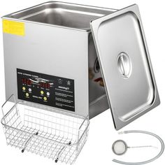 an electric deep fryer is shown with the lid open and wire basket next to it