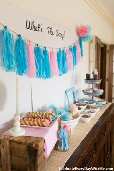 a dessert table filled with pastries and cupcakes