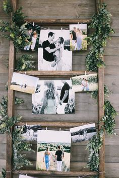 an old ladder is decorated with photos and greenery