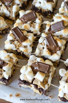 marshmallows and graham crackers are arranged on a baking sheet to be eaten