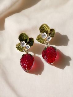 Strawberry earrings, fruit dangle earrings. Food earrings, glass earrings, handmade, gift for her, strawberries What's included: 1 x Pair of strawberry dangle earrings Materials: Glass Finish: 18K gold plated Earring Type: Pendant Style: Cool, Unique, Trendy, Minimalist, Vintage, Cute, Food 🔒 ENSURE ITS DURATION! Please note that these exquisite earrings are made of delicate zinc alloy, so it is recommended to avoid contact with liquids, sweat, creams and chemicals. To maintain their shine and Food Earrings, Small White Flowers, Red Strawberry, Romantic Valentine, Leaf Flowers, Crystal Drop Earrings, Red Crystals, Girls Jewelry, Fun Earrings