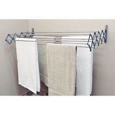 three white towels hanging on a towel rack