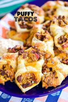 puffy tacos on a plate with other food items