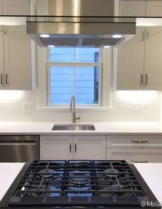 a stove top oven sitting inside of a kitchen