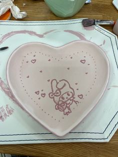 a heart shaped plate with a drawing on it