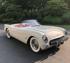 an old car is parked in the parking lot