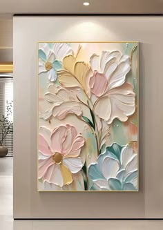 a painting on the wall in a room with white walls and flooring, along with a vase filled with flowers