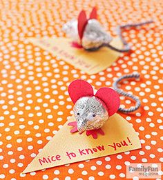 two little mouses are sitting on top of a table with red and white polka dots