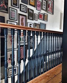 a stair case with many framed pictures on the wall