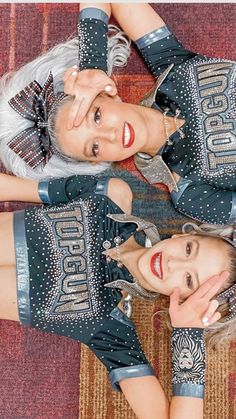 two women dressed in silver and black posing for the camera