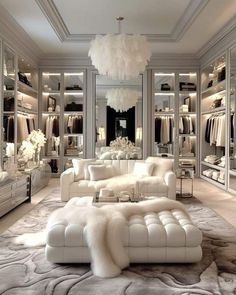 a white couch sitting in front of a walk in closet