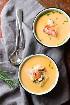 two bowls filled with soup on top of a table