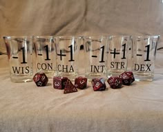 six shot glasses with numbers and dices on them