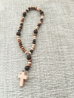 Multi-colored wooden beads make up this perfect mini rosary. **Note: each rosary is hand-made by order and may differ from image shown. Beaded Brown Rosary Gift, Black Wooden Beads Spiritual Rosary, Traditional Beaded Brown Rosary, Black Wooden Beads Rosary, Wooden Rosary, Mini Rosaries, Brown Cross-shaped Rosary With Wooden Beads, Dress Jewelry, How To Make Beads