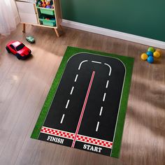 a child's play room with toys and rugs on the floor, including a toy car race track