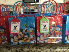 several mickey mouse bags with tags on them