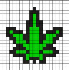 a cross stitch pattern with green and black squares in the shape of a flower on a white background